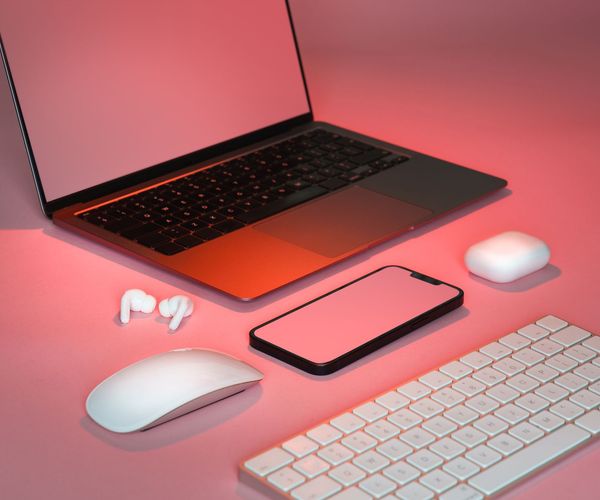 Minimalist tech workspace with soft lighting and pink accents